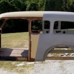 Old truck cab half blasted to bare metal