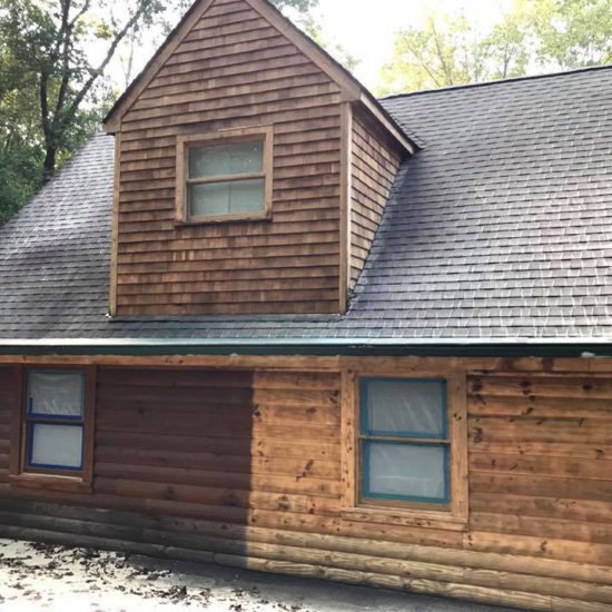 Log home siding half stripped, before and after